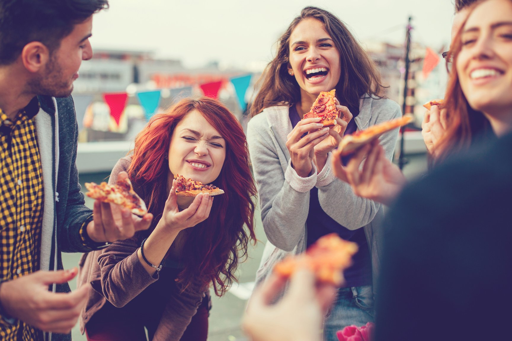 Young people eating pizza at party